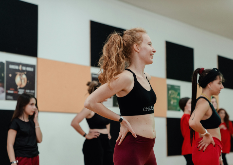 happy teacher, laughing and smiling in dance cl;ass
